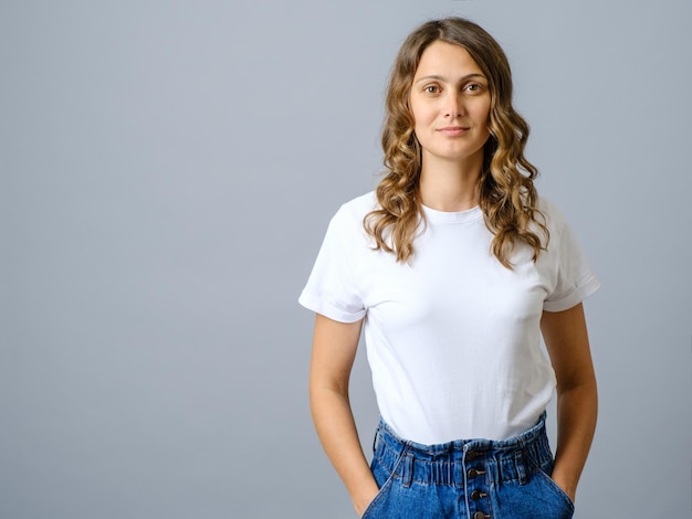 Happy successful woman in casual outfit smiling at camera and looking confident