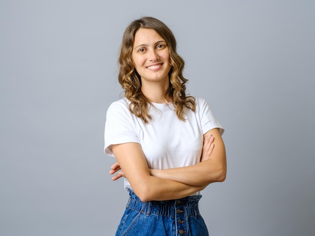 Happy successful woman in casual outfit smiling at camera and looking confident