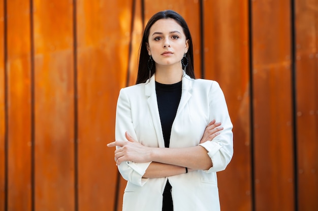 Happy successful woman professional posing near office building