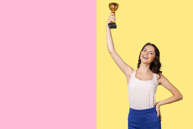 Photo happy successful woman with golden trophy. business success concept