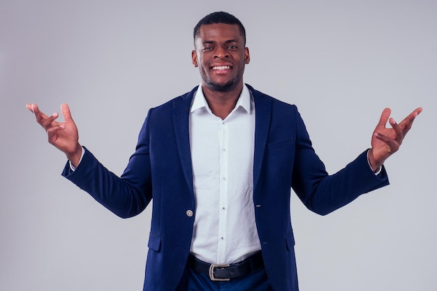 Happy successful young african american businessman portrait wearing a crown holding a laptop lottery winner