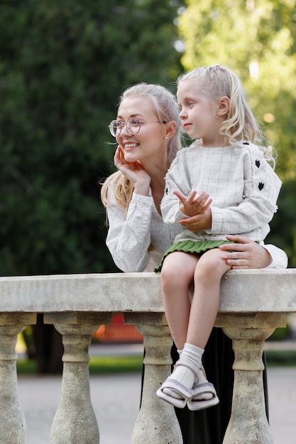 Happy summer family in the park smiling