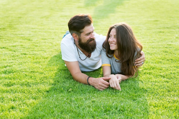 Happy summer. Happy family relax on green grass. Couple in love dating on natural landscape. Happy vacation. Family recreation. Enjoyment and relaxation. Being happy together.