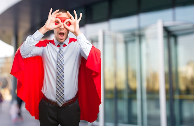 Happy super businessman doing a search gesture