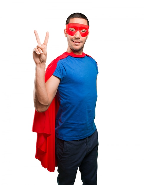 Happy superhero with victory gesture