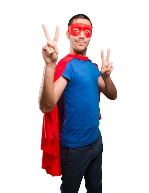 Happy superhero with victory gesture