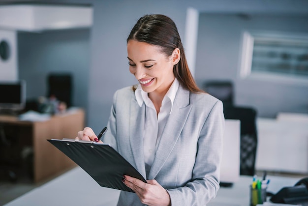 A happy supervisor evaluate employees at office