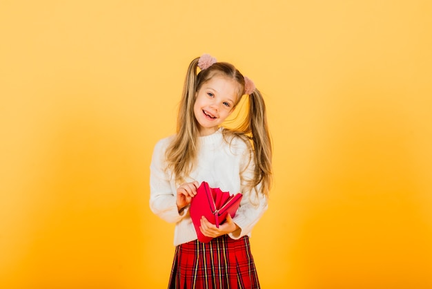 Happy surprised beautiful little child girl looking to camera on grey background. Human emotions