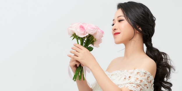 Happy surprised model woman smelling flowers Mother's Day Springtime