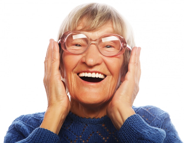 Happy surprised senior woman looking at camera