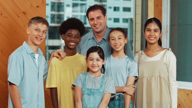 Happy teacher and diverse student standing while smiling to camera edification