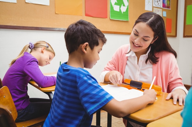 Happy teacher helping her students