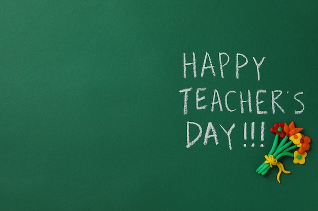 Happy teacher's day greetings inscription on a green board