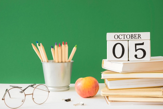 Photo happy teacher's day pencils and pile of books