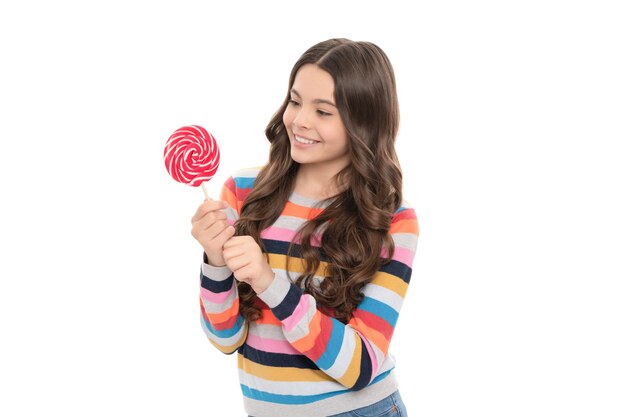 Happy teen girl in colorful sweater with lollipop candy on stick isolated on white background candy shop