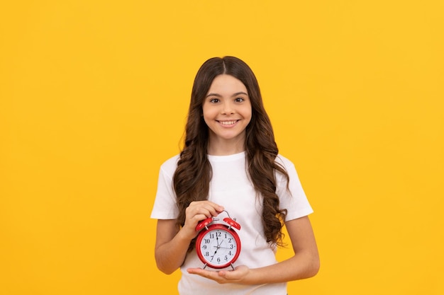 Photo happy teen girl hold retro alarm clock showing time time