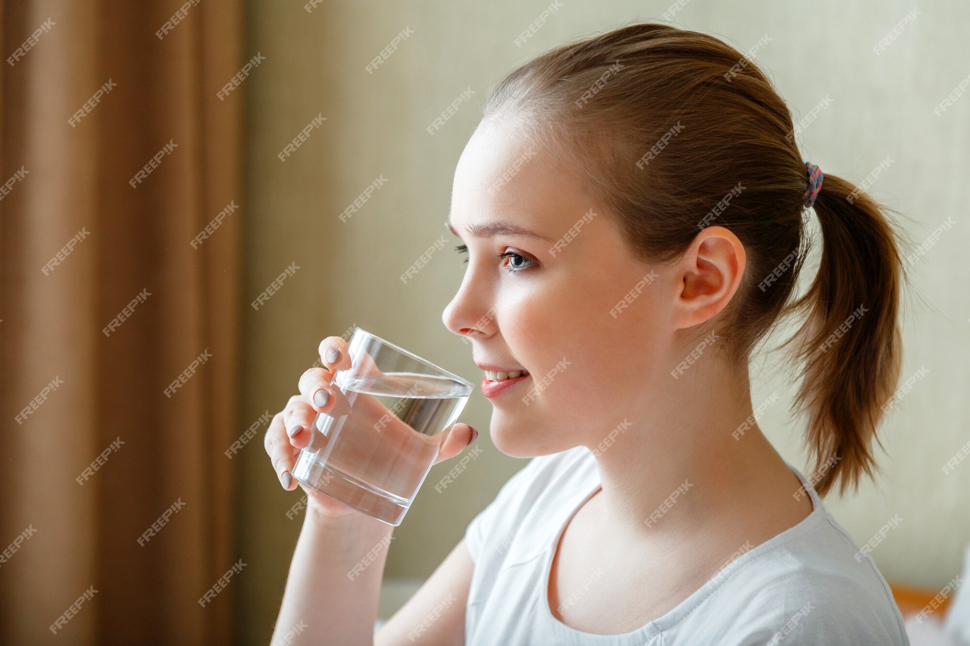 Premium Photo  Teen holds water bottle isoalted on yellow child girl care  body hydration active leisure and water balance active and healthy kid drink  water happy teenager portrait smiling girl