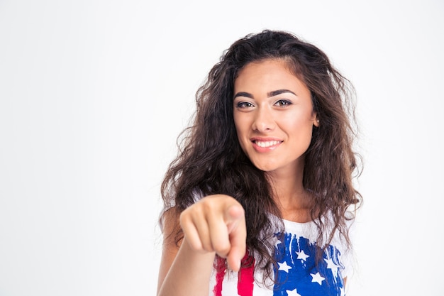 Happy teen girl pointing finger to the front