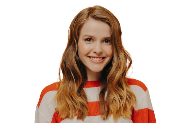 Happy teen girl sending positive energy to someone while standing isolated over yellow background