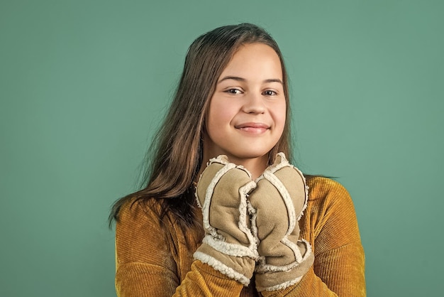 Happy teen girl wear warm winter clothes childhood happiness winter holiday activity child in knitted sweater and mittens feel cozy wearing comfortable apparel in cold season