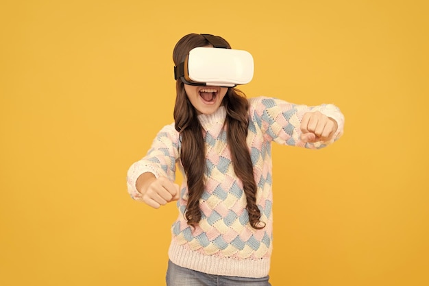 Happy teen girl wear wireless VR glasses using VR headset kid play video game Digital future