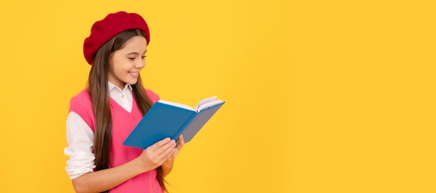 Happy teen school girl in french beret reading book on yellow background reader Banner school girl