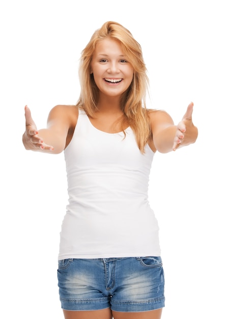 happy teenage girl in blank white t-shirt showing greeting gesture