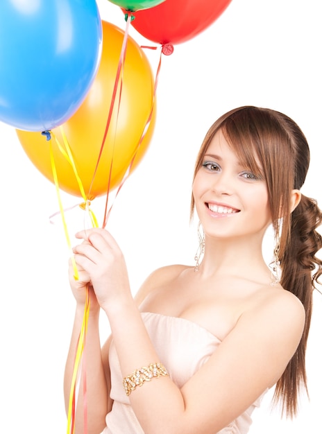 happy teenage girl with balloons over white