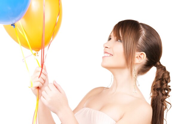 happy teenage girl with balloons over white