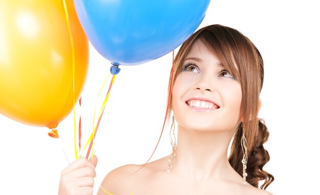 happy teenage girl with balloons over white