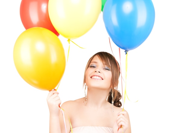 happy teenage girl with balloons over white