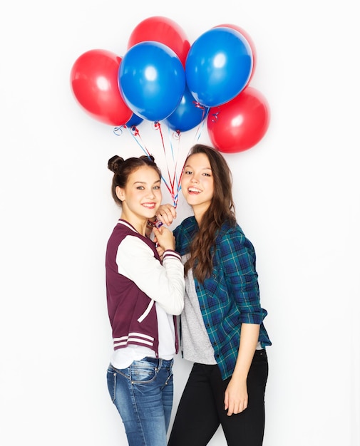 happy teenage girls with helium balloons