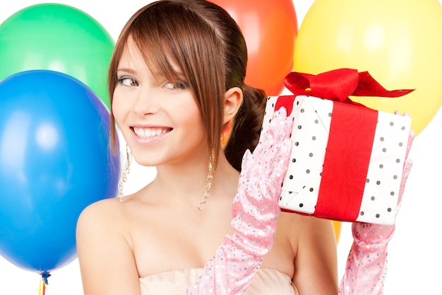 happy teenage party girl with balloons and gift box