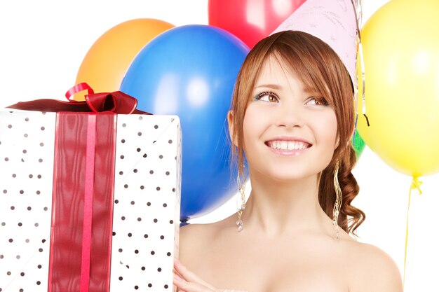 happy teenage party girl with balloons and gift box