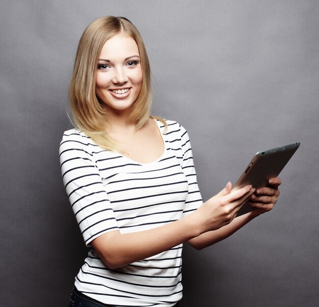 Happy teenage woman  with tablet pc computer