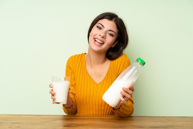 Happy Teenager girl having breakfast milk