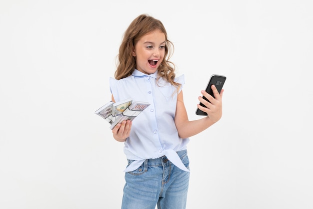 Happy teenager girl holding money on a white with copy space