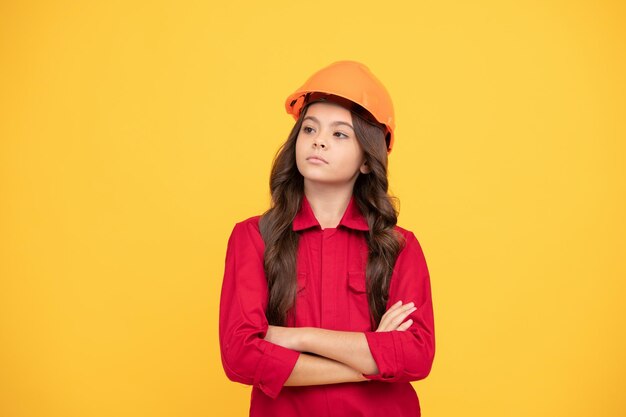 Happy teenager girl in safety hard hat labor day