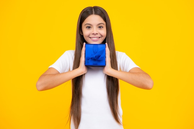 Happy teenager portrait child teen girl 1214 years old with gift on isolated background birthday holiday concept teenager hold present box smiling girl