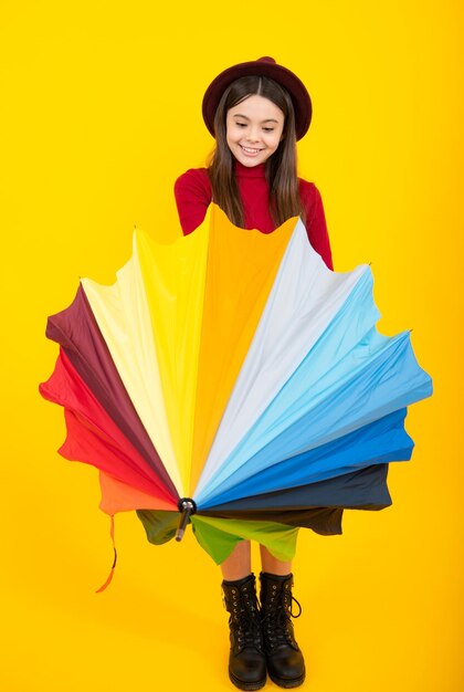 Happy teenager portrait Child teenager girl with umbrella on yellow studio background Excited teenager glad amazed and overjoyed emotions Smiling girl