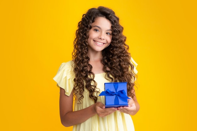 Happy teenager portrait cute teenager child girl congratulate with valentines day giving romantic gift box present greeting and gifting birthday concept smiling girl