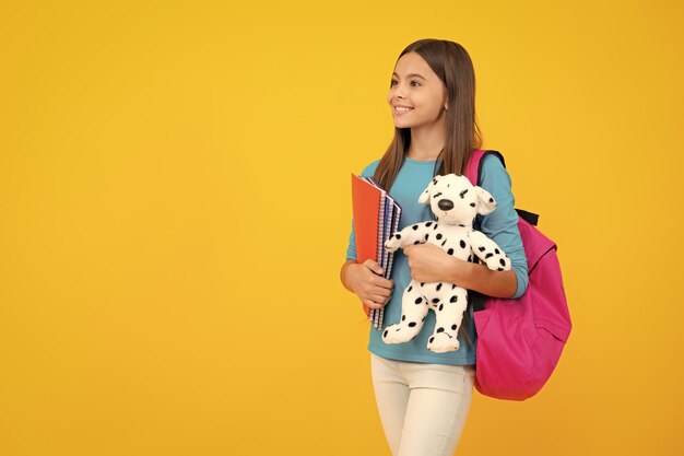 Happy teenager portrait Funny school girl with toy Happy childhood and kids education Knowledge day Smiling girl