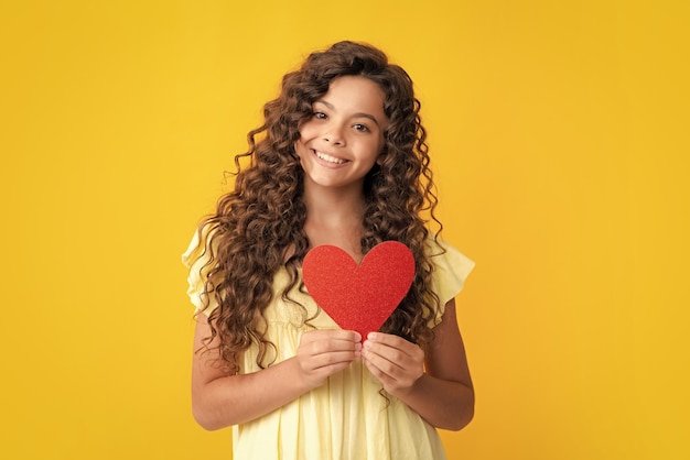 Happy teenager portrait lovely romantic teenage girl hold red heart symbol of love for valentines