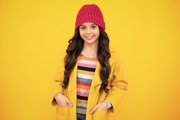 Happy teenager positive and smiling emotions of teen girl emotional portrait of caucasian teenager child girl isolated on studio yellow background