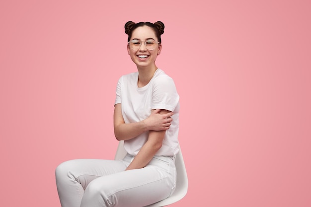 Happy teenager sitting on chair