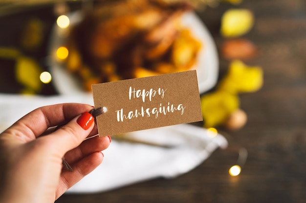 Happy Thanksgiving Autumn composition with leaves ripe pumpkin and Thanksgiving turkey on a dark wooden table Top view