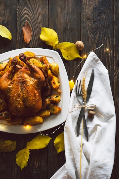 Happy thanksgiving autumn composition with leaves ripe pumpkin\
and thanksgiving turkey on a dark wooden table top view