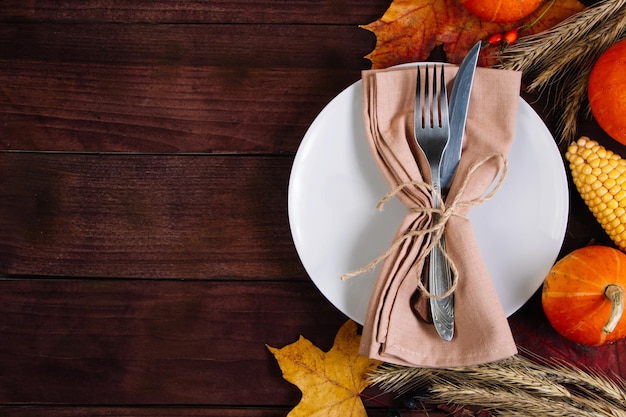Happy Thanksgiving Day Festive table setting on brown wooden background Place for text