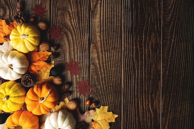 Happy Thanksgiving Day with pumpkin and nut on wooden table