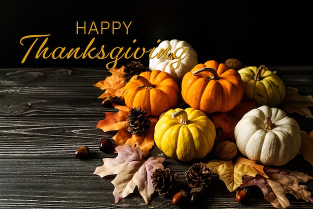 Happy Thanksgiving Day with pumpkin and nut on wooden table